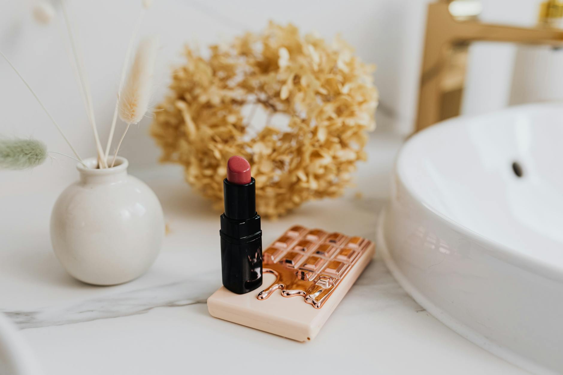 bright minimalist bathroom vanity with skincare and makeup neatly arranged next to a small return mailer box and a printed return confirmation