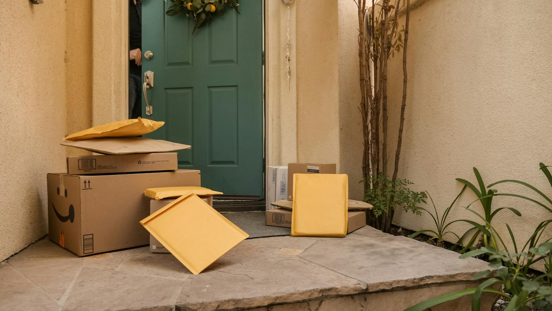 outdoor apparel and hiking boots arranged neatly near a front door with a return box and receipt on a console table