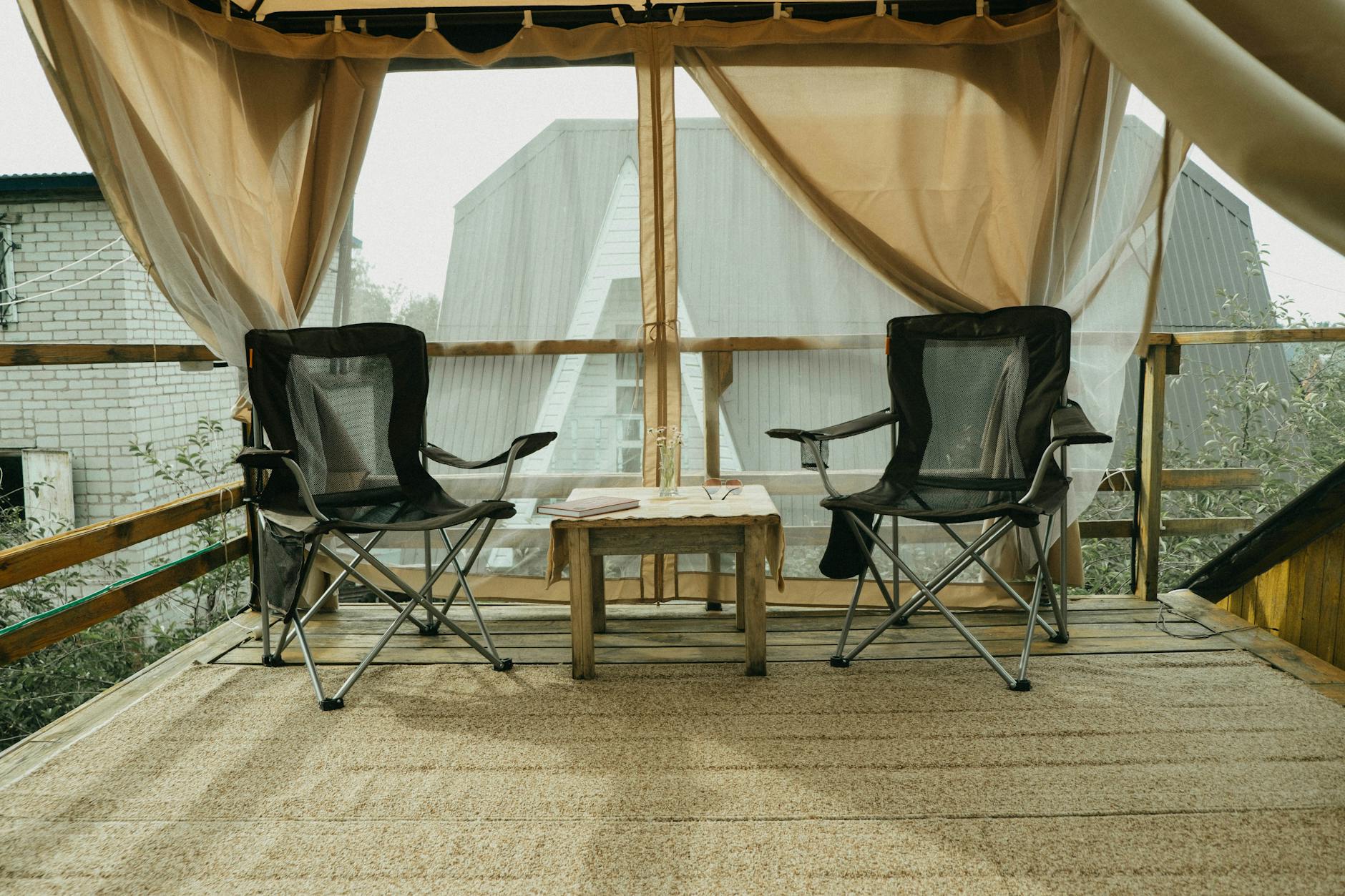 Budget-Friendly Patio Makeover Ideas for Summer 1 stylish small business patio with interlocking deck tiles, neutral outdoor rug, and a bistro set under soft morning light